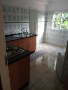 a kitchen with a sink and a stove in it at Holiday Home T3 to T6 on suite in Amparo II