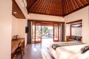 a bedroom in a villa with a bed and a desk at Taru Sebatu Villa in Ubud +73 photos