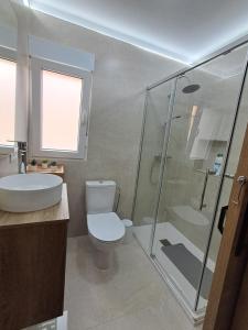 a bathroom with a shower and a toilet and a sink at Andrea's house in Charco del Pino