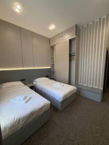 a room with two beds and a closet at Ave Garden in Osh