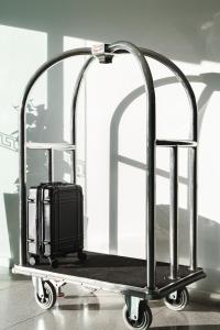 a metal luggage cart with a suitcase on it at Punthill Narrabundah in Canberra