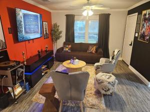 a living room with a couch and a table at 3BR Houston with Grill, Hot Tub and Game Room near NRG, Downtown and Hobby Airport in Houston