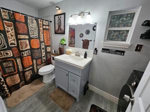 a bathroom with a white sink and a toilet at 3BR Houston with Grill, Hot Tub and Game Room near NRG, Downtown and Hobby Airport in Houston +75 photos