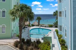 a view of the pool and ocean from the balcony of a building at Spacious Ocean View Apartments with Balcony in Blue Bay in Blue Bay