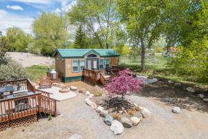 a log cabin with a deck and a yard at Durango RV Resort in Durango