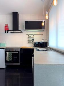a kitchen with a sink and a stove at ins Ígnea in Madalena +9 photos