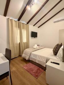 a bedroom with two beds and a television in it at Venice Star Villa in Mestre