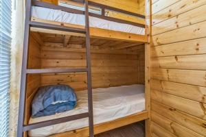 a bunk bed in a wooden cabin with a ladder at Durango RV Resort in Durango +22 photos