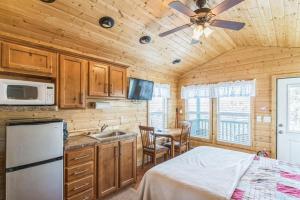 a kitchen with wooden walls and a ceiling with a ceiling fan at Durango RV Resort in Durango
