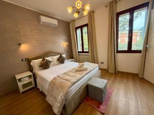 a bedroom with a large bed and two windows at Venice Star Villa in Mestre