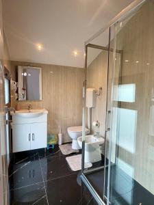 a bathroom with a toilet and a sink and a shower at Venice Star Villa in Mestre