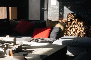 a living room with a couch with pillows at RoheN ASHINOKO in Hakone