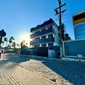 an empty street in front of a building at Family Beach flat - frente ao mar in Barra de São Miguel