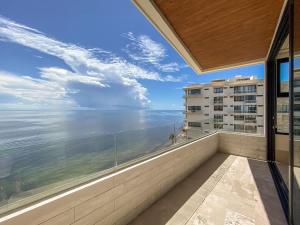 a balcony with a view of the ocean at Distrito Puerto by Andiani Travel in Puerto Morelos +47 photos
