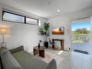 a living room with a couch and a table at Bay View 2-Bedroom Apartment in Batemans Bay