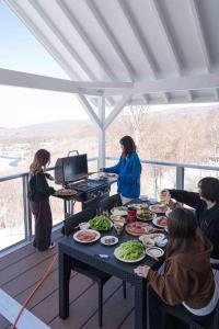 a group of people standing around a table with food at 白樺湖Lake View in Chino +101 photos