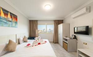 a hotel room with a bed with shoes on it at pyramids View Top in Cairo