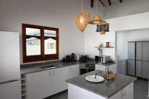 a kitchen with white cabinets and a counter top at Villa Belle Ile en Mer in Capesterre +9 photos