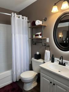 a bathroom with a white toilet and a sink at Beaver Motel in Wawa +22 photos