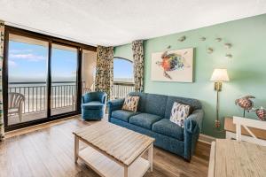 a living room with a couch and a table at Beautifully Decorated Condo with Amzing Ocean View in Myrtle Beach