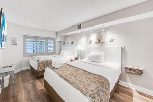 a hotel room with two beds and a chair at Beautifully Decorated Condo with Amzing Ocean View in Myrtle Beach