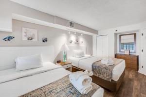 a hotel room with two beds and a window at Beautifully Decorated Condo with Amzing Ocean View in Myrtle Beach