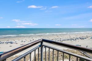 a view of a beach with people and the ocean at Beautifully Decorated Condo with Amzing Ocean View in Myrtle Beach