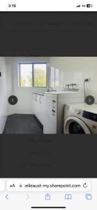 a kitchen with a sink and a washing machine at LingaLonga in Busselton +2 photos