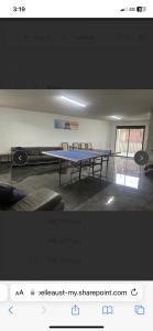a ping pong table in a room with chairs at LingaLonga in Busselton