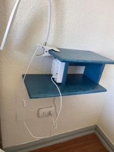 a blue shelf with a router on a wall at Apartamento Playa Mar Azul in El Quisco