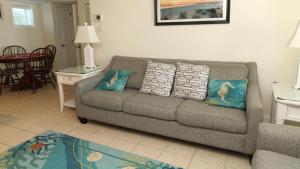 a living room with a couch with pillows on it at Condo At The Cove Unit 5 in Cape May