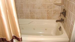 a white bath tub in a bathroom with a shower curtain at Condo At The Cove Unit 5 in Cape May +14 photos