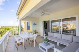 a living room with a couch and a table at Spacious Ocean View Apartments with Balcony in Blue Bay in Blue Bay