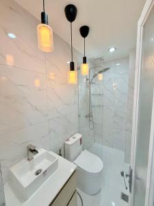 a bathroom with a toilet and a sink and a shower at Dasma stay - Private Jacuzzi and Skyline Views in Dasmariñas
