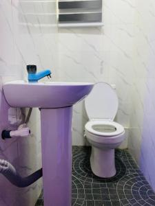 a bathroom with a sink and a toilet at Luxury and premium one bed in Ikeja