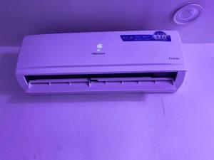 a printer sitting on top of a purple wall at Luxury and premium one bed in Ikeja