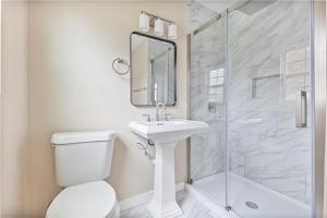a bathroom with a toilet and a sink and a shower at 5 beds 2 bath, sleep 10 in Corpus Christi +8 photos