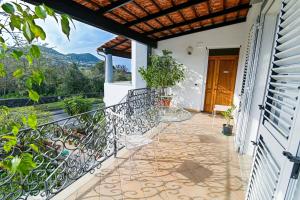 a balcony with a table and a view of the mountains at Rosa di Ischia - Holiday in Ischia Town