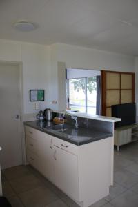 a kitchen with a sink and a counter top at Pakiri Beach Holiday Park in Pakiri +99 photos