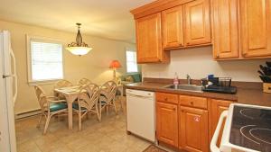 a kitchen with wooden cabinets and a table with chairs at 215 Heritage Lane in Cape May