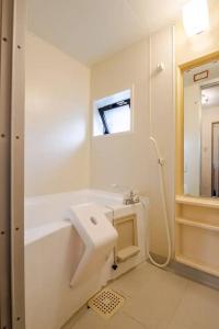 a bathroom with a sink and a bath tub at B桜坂Sakurazaka APT in Susakiuramachi +25 photos