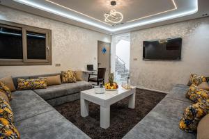 a living room with a couch and a table at Villa America Dakhla in Dakhla
