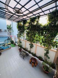 a balcony with potted plants on a building at Lê Gia HOUSE KG in Kiên Lương +10 photos