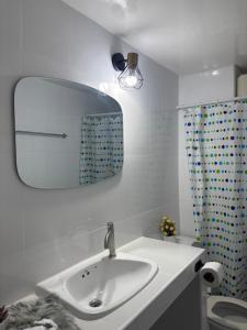 a bathroom with a sink and a mirror on the wall at Ally home 0624 in Thung Si Kan +2 photos