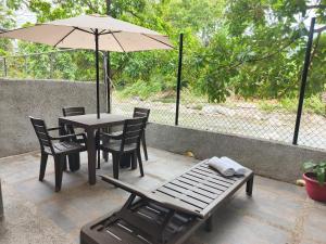 a table and chairs with an umbrella on a patio at Casa Terraza in El Zaino