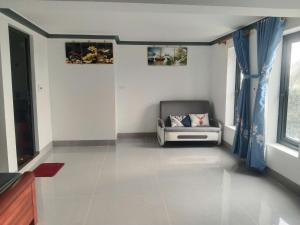 a living room with a couch and a window at Kì thanh hotel in Thanh Hóa