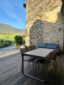 a table and chairs sitting on a wooden deck at La Source in Rustrel