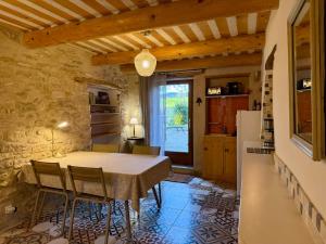 a kitchen and dining room with a table and chairs at La Source in Rustrel +67 photos