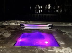 a purple pool on the ground at night at Superb 3brm - Spacious, GamesSpaSaunaGym in Mont-Tremblant
