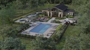 an aerial view of a house with a swimming pool at Superb 3brm - Spacious, GamesSpaSaunaGym in Mont-Tremblant